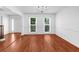 Bright and airy living room with hardwood floors, a chandelier, and views to the front yard at 1410 Kingfield Dr, Johns Creek, GA 30005