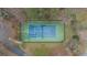 Aerial view of a well-maintained tennis court surrounded by trees at 1410 Kingfield Dr, Johns Creek, GA 30005