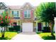 Charming townhouse with colorful shutters, a well-manicured lawn and an attached single-car garage at 7104 Georges Way, Morrow, GA 30260