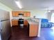 Bright kitchen featuring stainless steel appliances, wood cabinets, and hardwood floors at 7104 Georges Way, Morrow, GA 30260