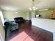 Open-concept living room with wood floors, two sofas, and a breakfast bar with views to the kitchen at 7104 Georges Way, Morrow, GA 30260
