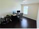 Bright home office with wood flooring, a desk with dual monitors and bookshelves, plus natural light at 7104 Georges Way, Morrow, GA 30260