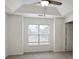 This neutral bedroom features a tray ceiling, fan, light bright window, and neutral carpet at 1731 Pryor Sw Rd # 307, Atlanta, GA 30315