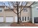 Two-story townhome featuring a garage and door opening to back; tree in front yard at 1731 Pryor Sw Rd # 307, Atlanta, GA 30315