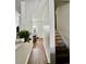 Hallway with hardwood flooring leads to the staircase with carpet and a bright dining room at 1731 Pryor Sw Rd # 307, Atlanta, GA 30315