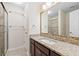 Bathroom with granite countertop vanity, mosaic backsplash, and glass-enclosed shower at 4140 Riverlook Parkway Se Se Pkwy # 209, Marietta, GA 30067