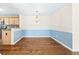 Open dining area featuring hardwood floors, a stylish chandelier and half wall to the kitchen at 4140 Riverlook Parkway Se Se Pkwy # 209, Marietta, GA 30067