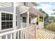 Inviting front porch featuring white railings, gray siding and doors and a peaceful, shaded sitting area at 4140 Riverlook Parkway Se Se Pkwy # 209, Marietta, GA 30067