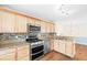 Charming kitchen with stainless steel appliances, granite countertops, mosaic backsplash, and wooden cabinetry at 4140 Riverlook Parkway Se Se Pkwy # 209, Marietta, GA 30067