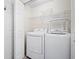 Bright laundry area with white washer and dryer hookups and shelving at 4140 Riverlook Parkway Se Se Pkwy # 209, Marietta, GA 30067