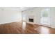 Living room featuring hardwood floors, fireplace, neutral walls, and large windows and a glass panel door at 4140 Riverlook Parkway Se Se Pkwy # 209, Marietta, GA 30067