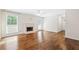 Spacious living room featuring hardwood floors, fireplace, neutral walls, and large windows with lots of natural light at 4140 Riverlook Parkway Se Se Pkwy # 209, Marietta, GA 30067