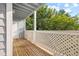 Covered outdoor patio with lattice and view of trees at 4140 Riverlook Parkway Se Se Pkwy # 209, Marietta, GA 30067