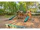 Community playground with wood play structure, slides, and mulch ground covering at 4140 Riverlook Parkway Se Se Pkwy # 209, Marietta, GA 30067