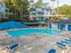 Community pool with lounge chairs and surrounding landscape at 4140 Riverlook Parkway Se Se Pkwy # 209, Marietta, GA 30067