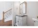 Half bathroom featuring decorative cabinet with marble top and unique mirror at 5139 Peachtree Road, Chamblee, GA 30341