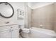 Bright bathroom featuring a white vanity, updated fixtures, and a shower-tub combination with tile surround at 5139 Peachtree Road, Chamblee, GA 30341