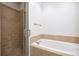 Bathroom featuring walk-in shower and soaking tub at 5139 Peachtree Road, Chamblee, GA 30341