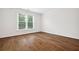 Bright bedroom with wood floors and a large window at 5139 Peachtree Road, Chamblee, GA 30341