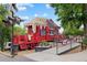 The front of a red caboose-themed building with a ramp and train signal nearby at 5139 Peachtree Road, Chamblee, GA 30341