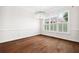 Bright and airy dining room featuring hardwood floors, large windows, and modern chandelier at 5139 Peachtree Road, Chamblee, GA 30341