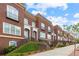 Beautiful brick townhome exteriors ascend from the sidewalk to individual front doors at 5139 Peachtree Road, Chamblee, GA 30341