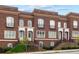 Charming brick townhomes feature front steps, petite balconies, and manicured landscaping at 5139 Peachtree Road, Chamblee, GA 30341