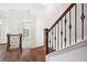 Foyer view showing hardwood floors and stairwell with decorative metal balusters at 5139 Peachtree Road, Chamblee, GA 30341