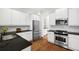 A chef's kitchen complete with stainless appliances and wood floors at 5139 Peachtree Road, Chamblee, GA 30341