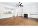 Open living room with fireplace, custom built-ins, and a view to the kitchen at 5139 Peachtree Road, Chamblee, GA 30341