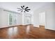 Bright main bedroom features hardwood floors, ceiling fan, and French doors at 5139 Peachtree Road, Chamblee, GA 30341