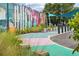 A unique outdoor space with a mural, landscaping, and colorful ground at 5139 Peachtree Road, Chamblee, GA 30341