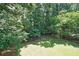 Backyard with a lush green lawn and a wooden fence at 5176 Shotwell St, Woodstock, GA 30188