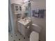 Cozy bathroom featuring neutral decor, toilet, sink, and storage at 5176 Shotwell St, Woodstock, GA 30188