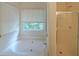 Bathroom with a bathtub and shower with glass door at 5176 Shotwell St, Woodstock, GA 30188