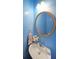 Charming powder room with blue walls, round mirror, pedestal sink and fresh flowers at 5176 Shotwell St, Woodstock, GA 30188