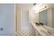 Bright bathroom with black and white flooring, double sinks, and walk-in shower at 5176 Shotwell St, Woodstock, GA 30188