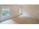 Bright bedroom featuring two windows with views of trees and blinds for privacy at 5176 Shotwell St, Woodstock, GA 30188