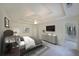 Bright bedroom featuring a tray ceiling, ceiling fan, and ensuite closet at 5176 Shotwell St, Woodstock, GA 30188