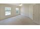 Bright bedroom with neutral carpet, ceiling fan, and two windows providing natural light at 5176 Shotwell St, Woodstock, GA 30188