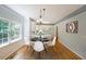 Staged dining area with hardwood floors, and access to the kitchen at 5176 Shotwell St, Woodstock, GA 30188