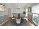 Bright dining room with hardwood floors, crown molding, with staged table and decorations at 5176 Shotwell St, Woodstock, GA 30188