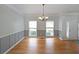 Bright dining room with hardwood floors, wainscoting, and large windows at 5176 Shotwell St, Woodstock, GA 30188