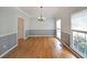 Bright dining room with hardwood floors, wainscoting, and large windows at 5176 Shotwell St, Woodstock, GA 30188