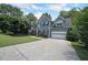 Beautiful two-story house showcasing a wide driveway, two-car garage and a green yard at 5176 Shotwell St, Woodstock, GA 30188