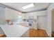 Kitchen with white cabinets, hardwood floors, and plenty of natural light at 5176 Shotwell St, Woodstock, GA 30188