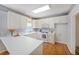 Bright kitchen with white countertops, appliances, hardwood floors, and plenty of natural light at 5176 Shotwell St, Woodstock, GA 30188