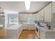 Spacious kitchen with white cabinets, modern appliances, hardwood floors, and ample counter space at 5176 Shotwell St, Woodstock, GA 30188