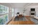 Living room featuring hardwood floors, a fireplace, and ample natural light at 5176 Shotwell St, Woodstock, GA 30188