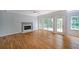 Cozy living room featuring a fireplace, hardwood floors, and natural light at 5176 Shotwell St, Woodstock, GA 30188